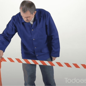 Man attaching a Barriers With TC114 Tensacone Topper
